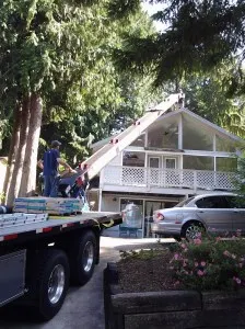 Here you can see my see-through windows, the really cool truck that loaded materials onto my roof for about a billion dollars an hour, and also the ghetto Jag, which looks pretty good until you lift up the hood.
