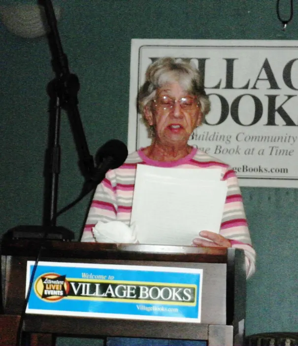 Sylvia Crosby reading her tale about a man who misses his wives and finds his son "slimy."